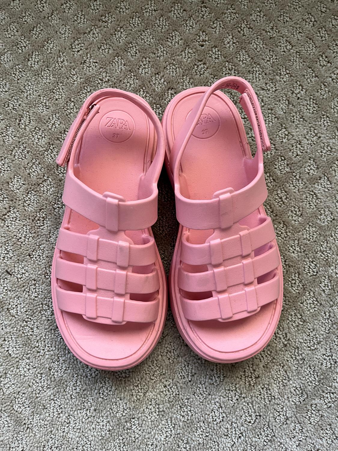 Front view of pink sandals with straps and a thick sole.