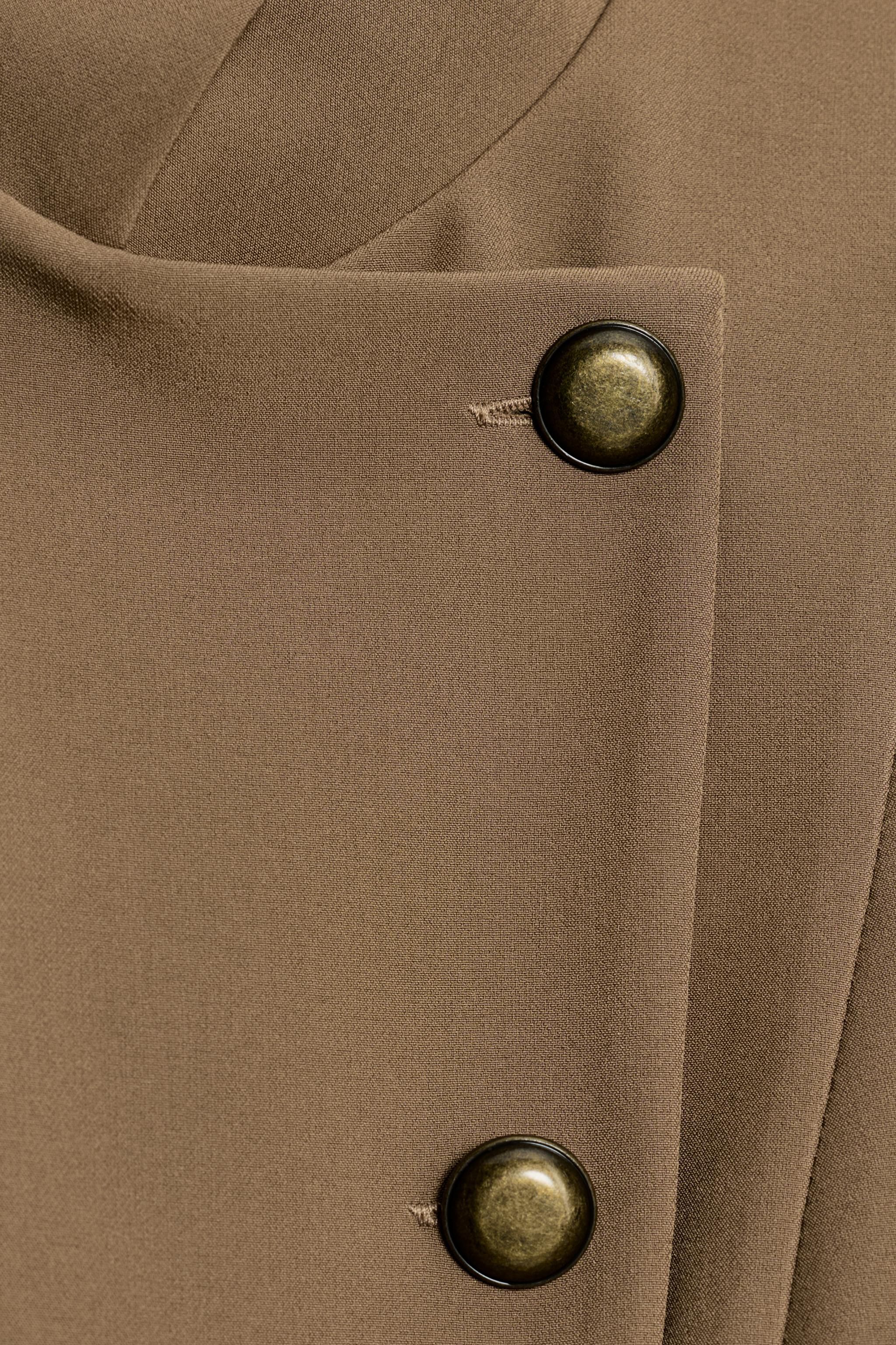 TOP GILET PEPLUM À BOUTONS