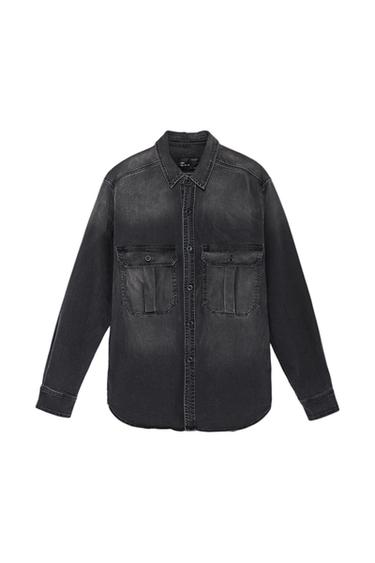 Black denim shirt with two front flap pockets and buttons. Long sleeve design and classic collar.