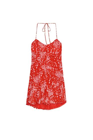 Front view of a red dress with white floral print and tie straps.