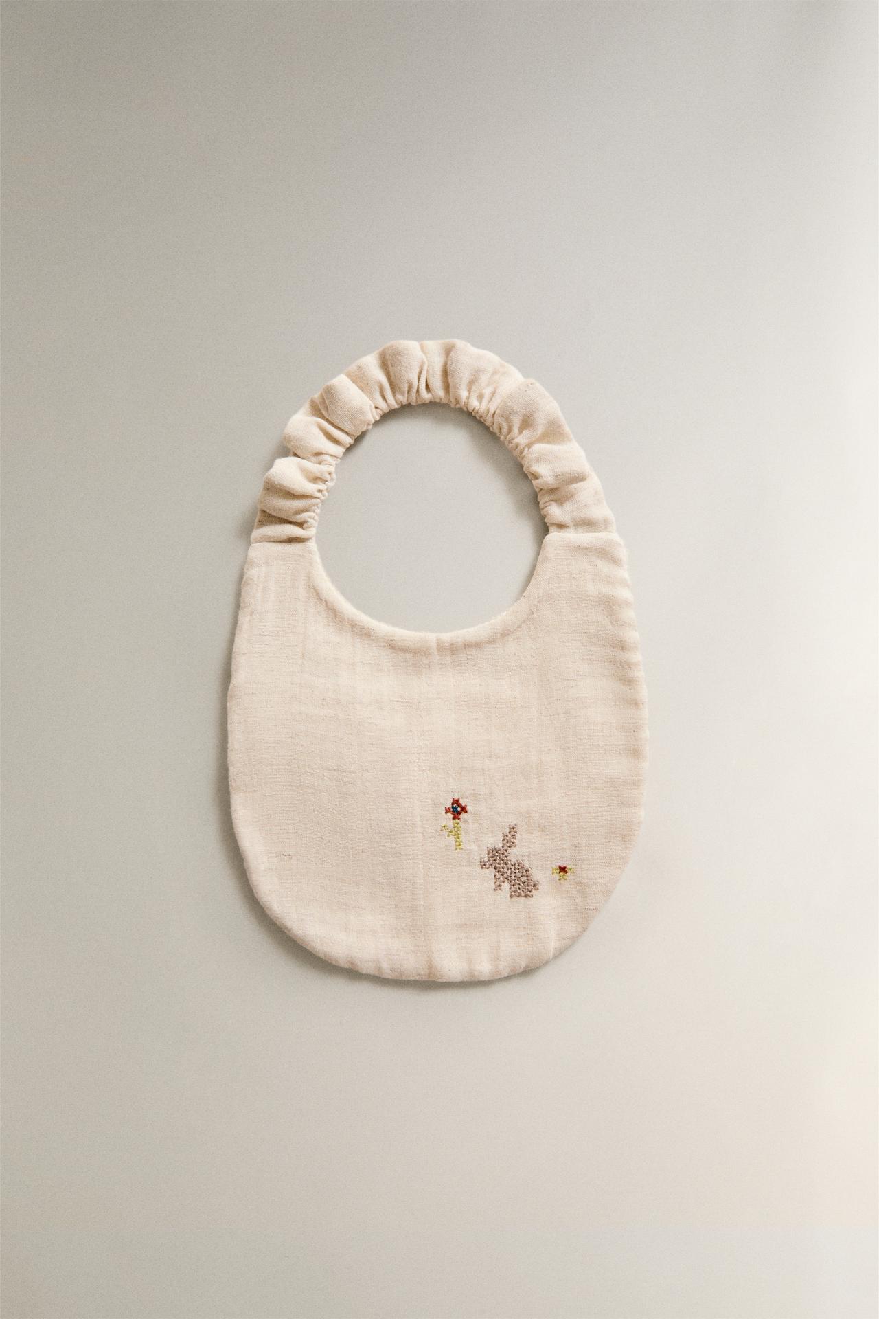 EMBROIDERED MUSLIN BABY BIB — Light beige