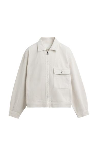 Front view of a beige jacket with zip and front flap pocket.
