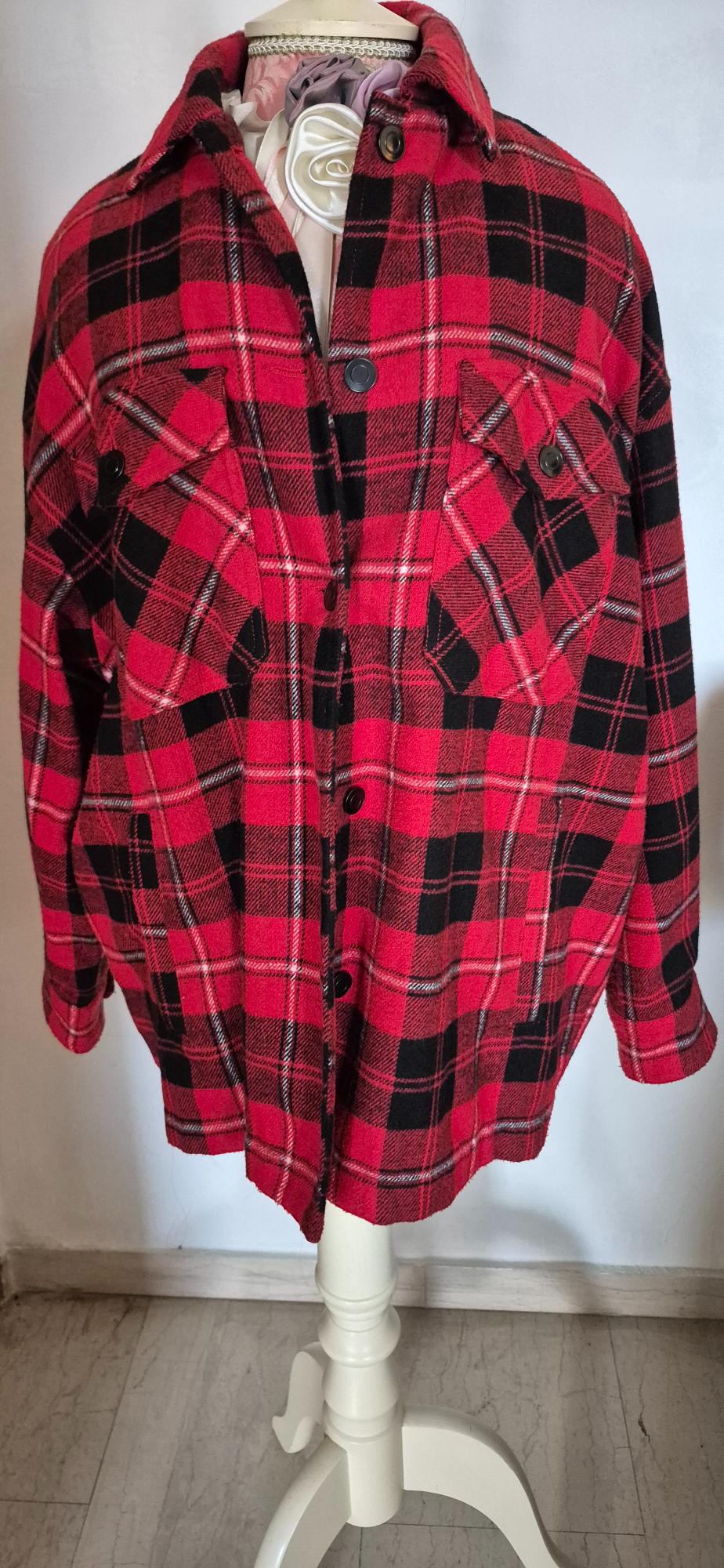 Red and black checked shirt with chest pockets, displayed on a white mannequin against a neutral background.
