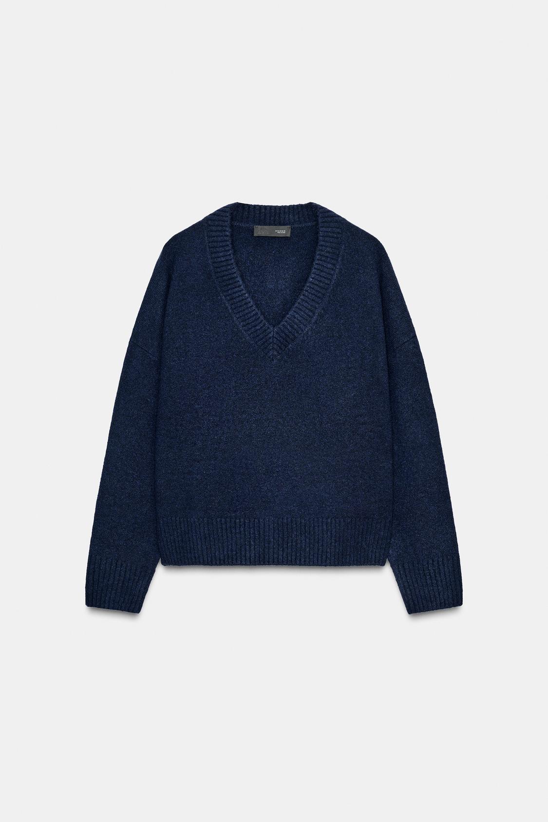 Front view of navy jumper with V-neck, long sleeves and ribbed trim.