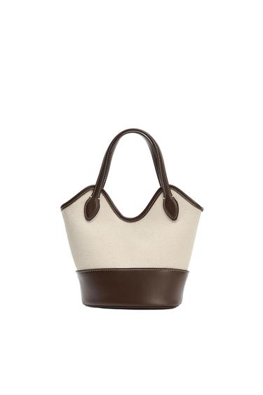 Beige fabric tote bag with a dark brown base, trim and handles with light-coloured stitching, on a white background.