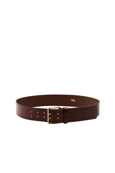 Front view of a mustard belt with a square metallic buckle and "ZARA" text.