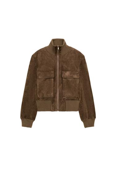 Front view of a light beige bomber jacket with a stand-up collar, flap patch pockets, and a front zip fastening.