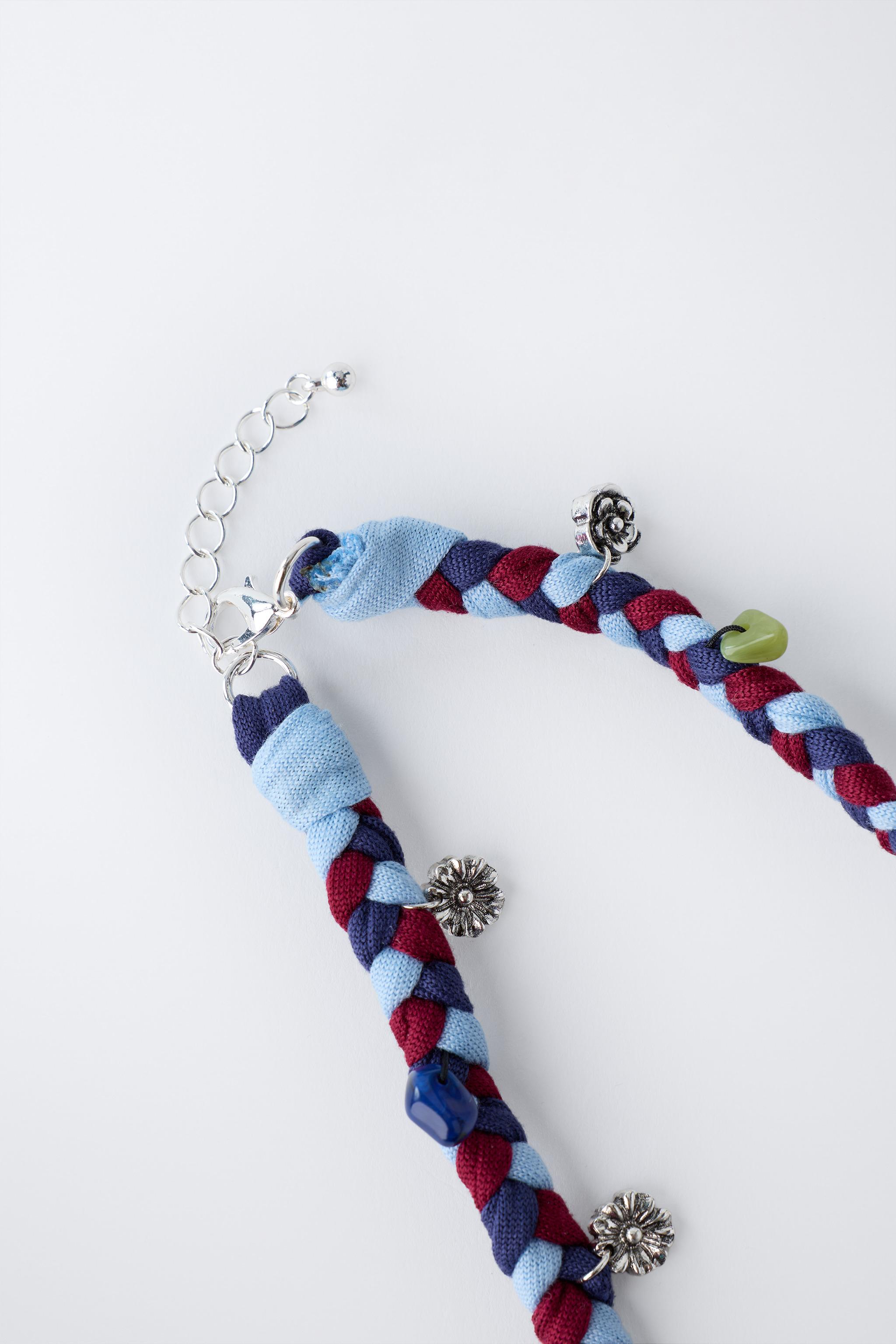 BRAIDED NECKLACE WITH FLOWER PENDANTS