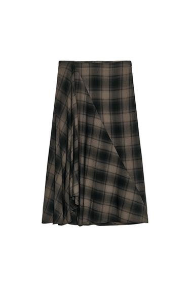 Front view of a black and brown midi skirt with a checked print and an asymmetrical hem. Side fastening with a concealed zip.