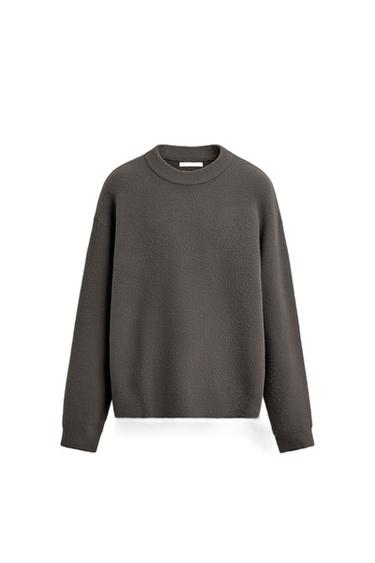 Front view of a taupe sweater with a hairy texture, round neck and long sleeves. Ribbed trims.