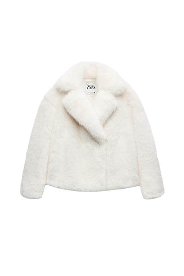 White faux fur jacket with wide lapels. Visible label with the text "ZARA". White background.