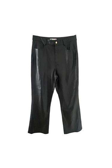 Black trousers made from shiny material with front pockets and a metal button, hung against a white background.