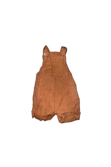 Brown baby romper with straps and buttons at the top, on a white background.