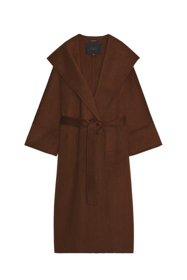 Front view of a long brown coat with a wrap collar, long sleeves, and an adjustable belt. Front pockets.
