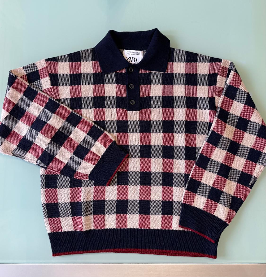 Large checked jumper in shades of pink, black, and white, with a polo collar and buttons. Visible "ZARA" label.