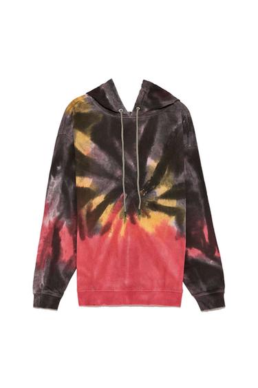 Front view of hooded sweatshirt, black, yellow, and red tie-dye print, drawstrings at the neck.