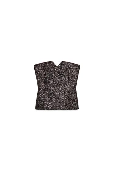 Front view of brown sequinned, strapless bustier top with front pleat. Zip fastening at the back.