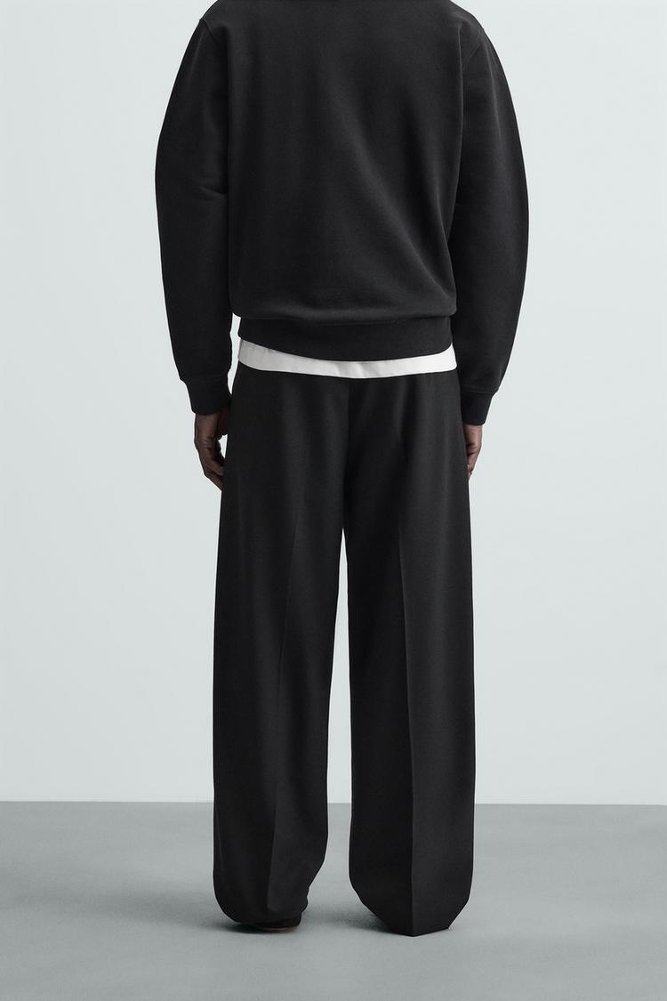 WIDE FIT PLEATED TROUSERS