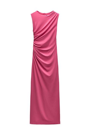 Long pink sleeveless dress with a side-gathered detail against a white background.