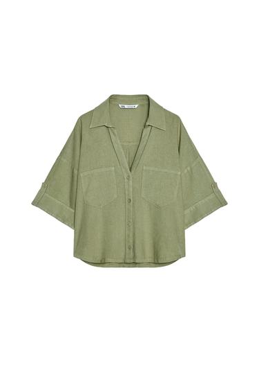 Front view of a green shirt with front pockets and short sleeves.