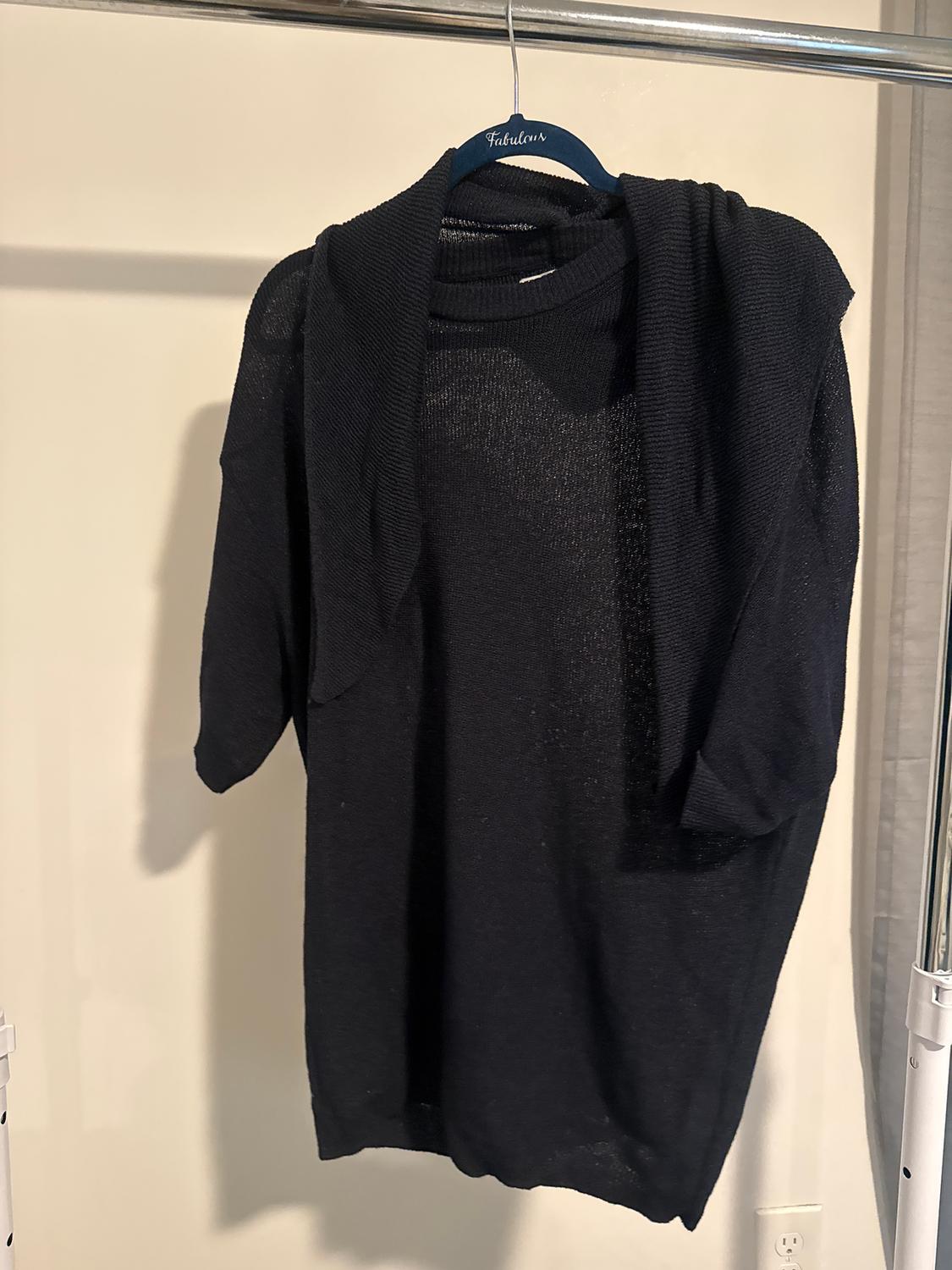 Black jumper hanging on a blue hanger with the brand "Fabulous" against a white background.