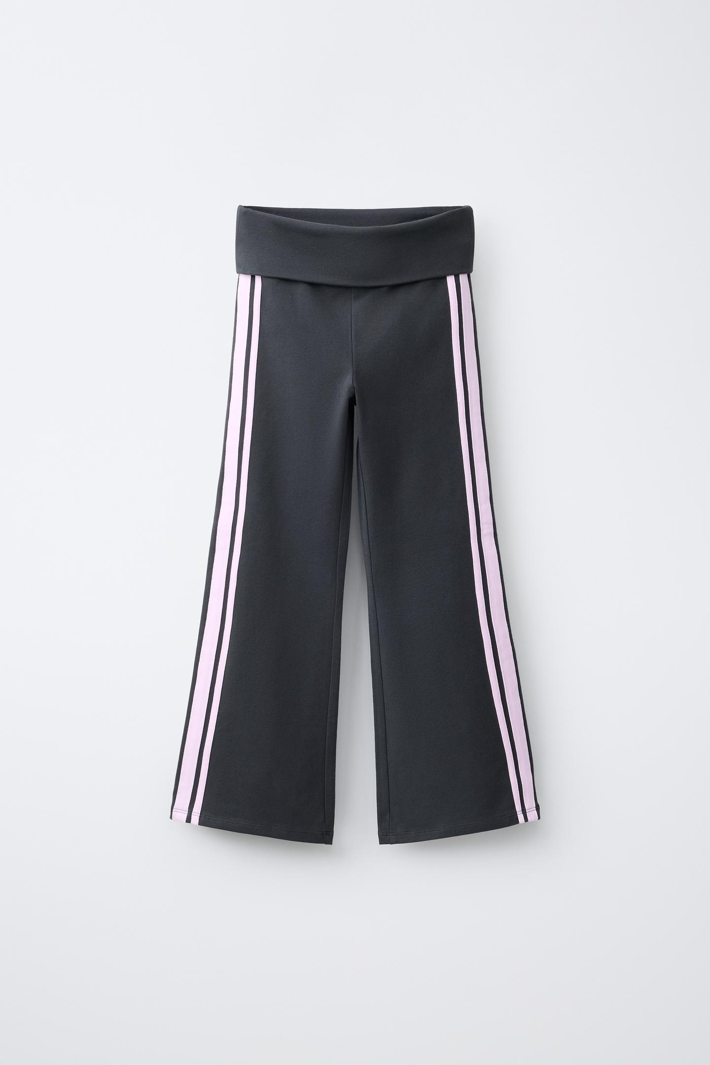 Front view of anthracite gray flare leggings with an elastic waistband and contrasting side stripes.