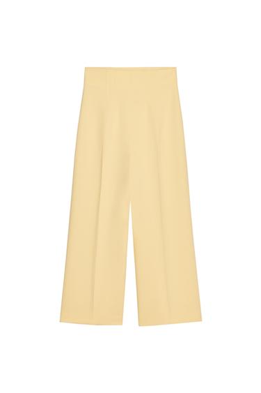 Front view of beige pleated culottes.