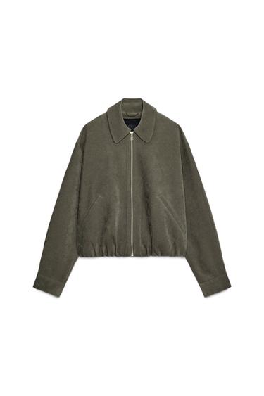 Front view of khaki bomber jacket with lapel collar, front zip, jetted front pockets and elasticated hem.