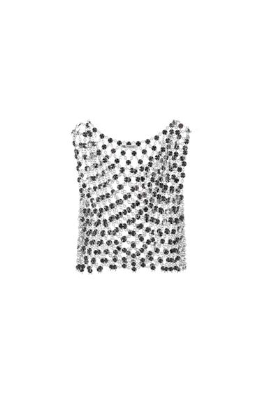Mesh top with black and silver sequins on a white background. Sleeveless design and round neck.