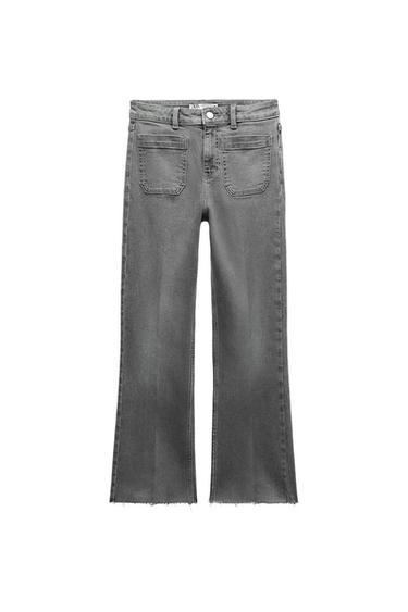 Grey flared jeans with front patch pockets and a frayed hem against a white background.
