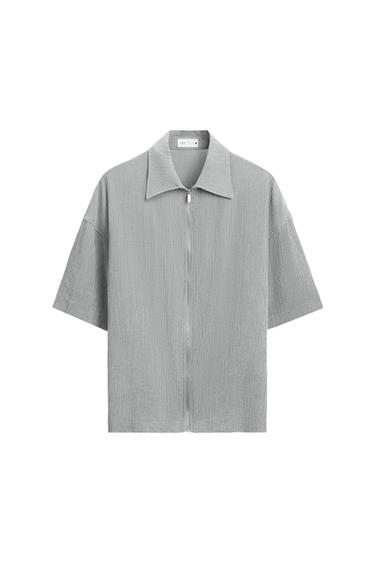 Front view of a grey zip-up shirt with a wide collar.