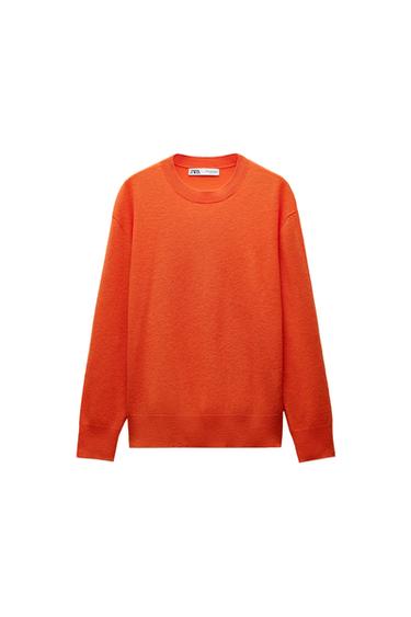 Front view of an orange jumper with a crew neck and long sleeves.