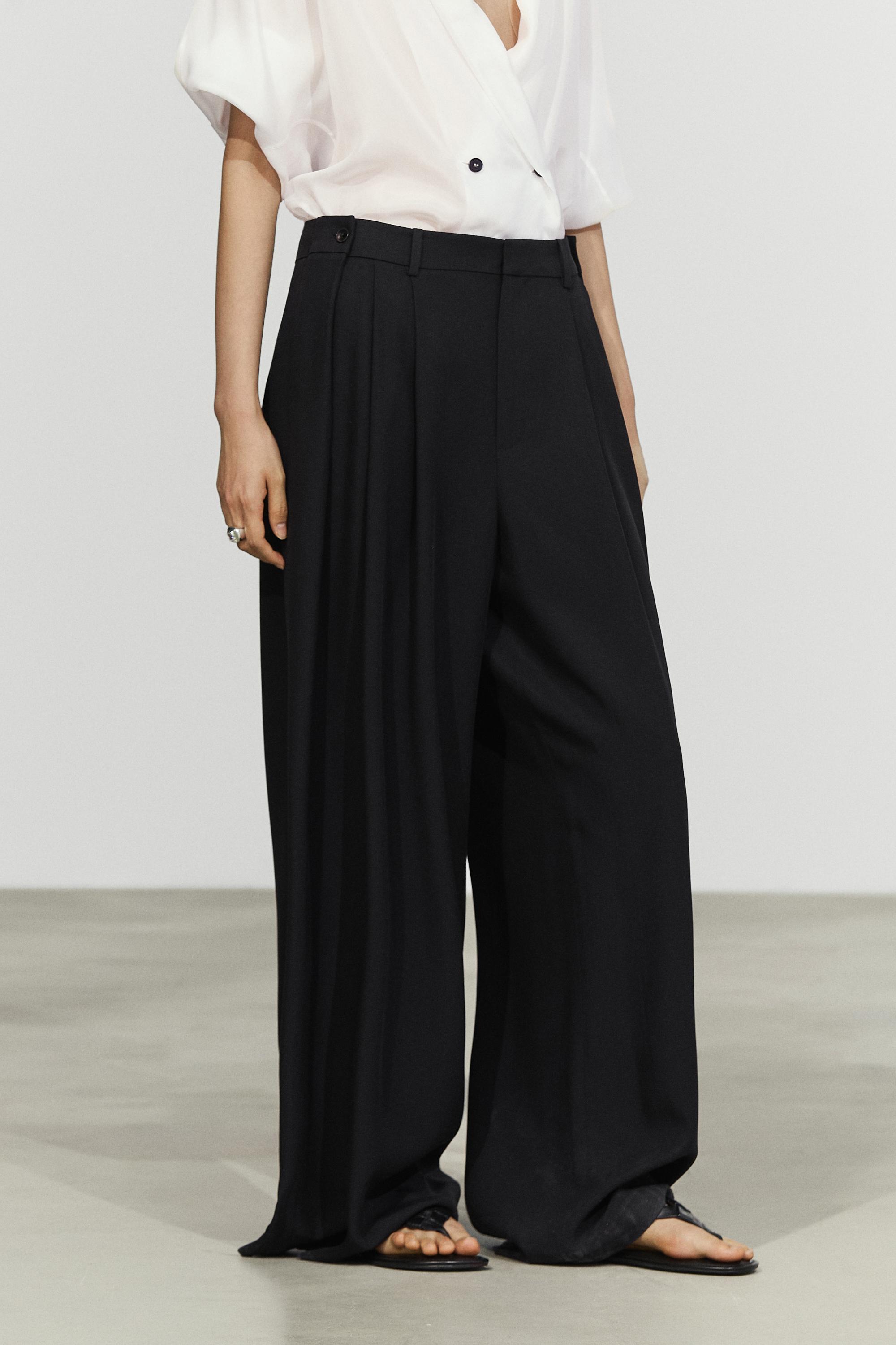 Flowing pleated pants with button detail — Black