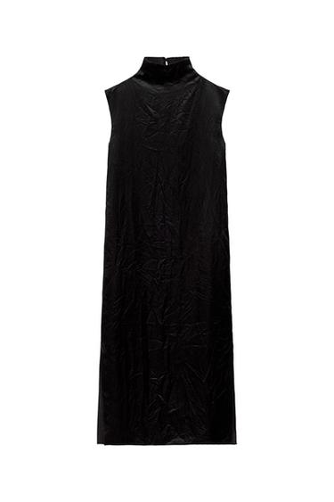 Front view of a black sleeveless, high-neck, knee-length dress.