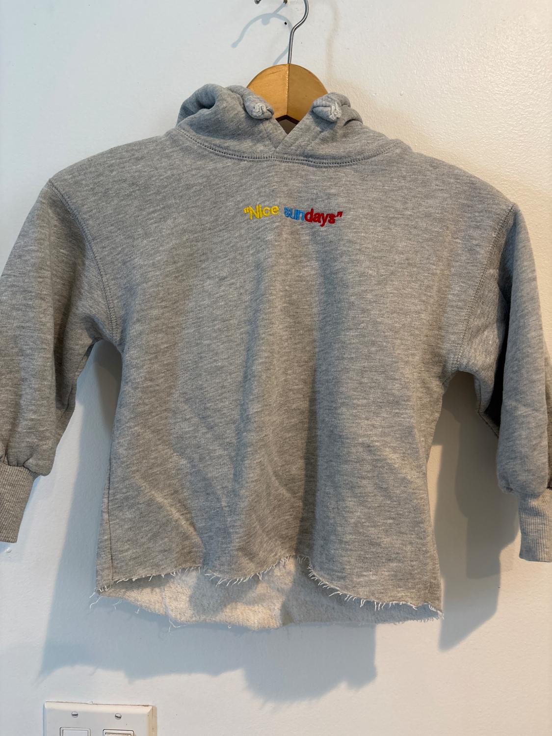 Back view of a gray hoodie with the text 'Nice our days' embroidered on the back.