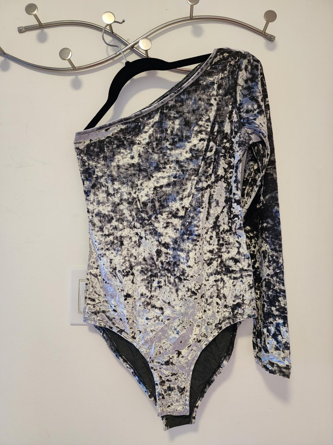 Front view of a black and gray marbled print velvet one-shoulder bodysuit.