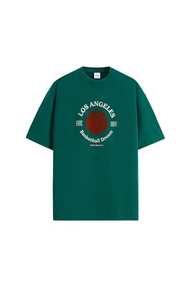 Green T-shirt with the text "LOS ANGELES Basketball Dream EST. 1975" and a drawing of a basketball in the centre.