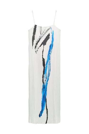 Front view of a white dress with thin straps and a blue and black abstract print.