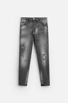 SPLATTERED RIPPED SKINNY JEANS
