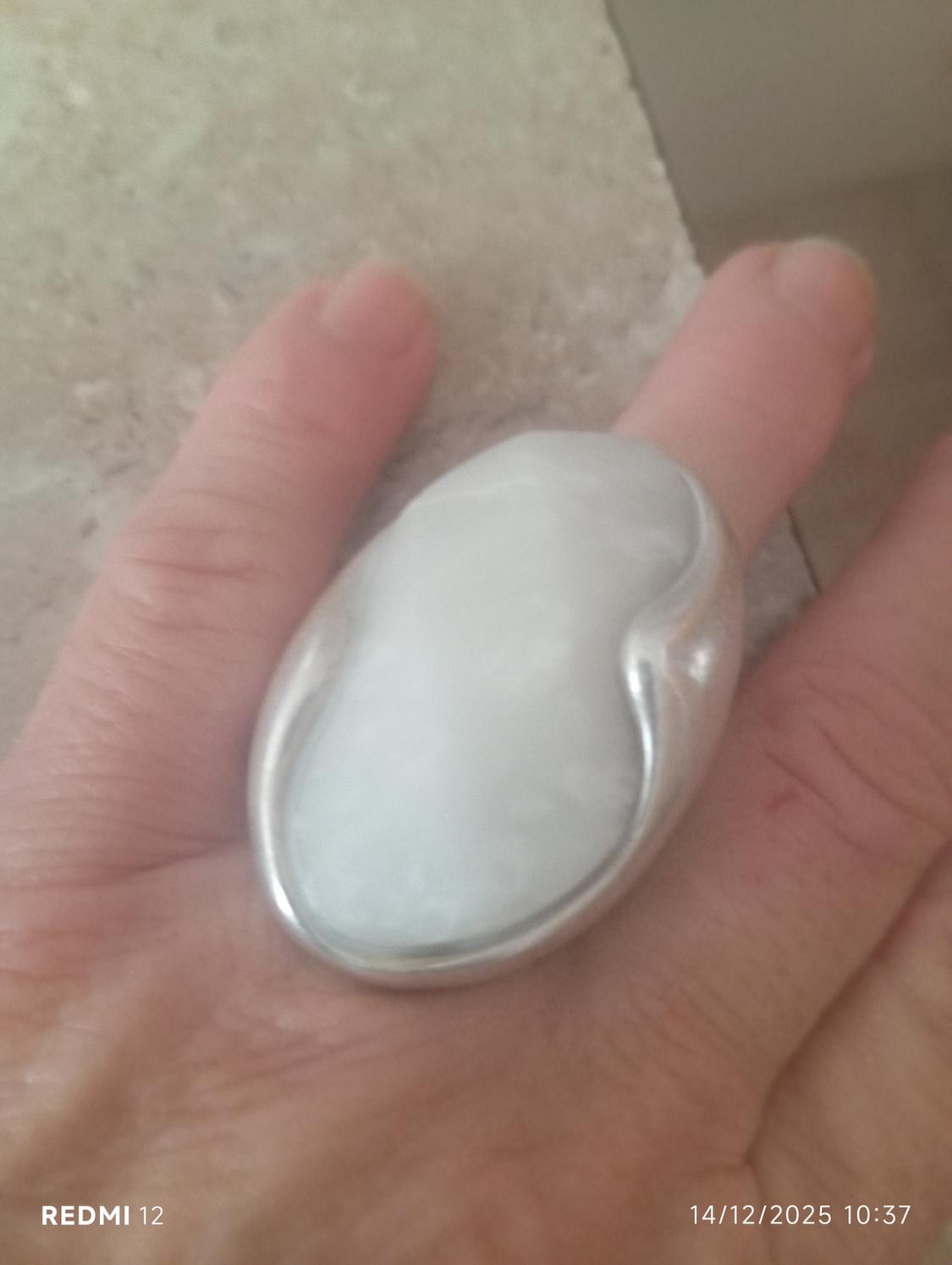 Hand with large white stone ring and silver-coloured edge. Text in image: "REDMI 12" and date "14/12/2025 10:37".
