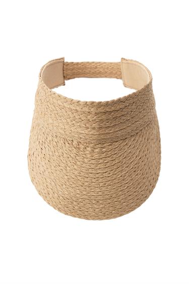 Front view of a beige straw visor with an adjustable closure.
