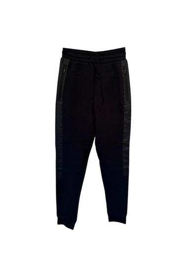 Front view of black trousers with side zip pockets and adjustable waistband.