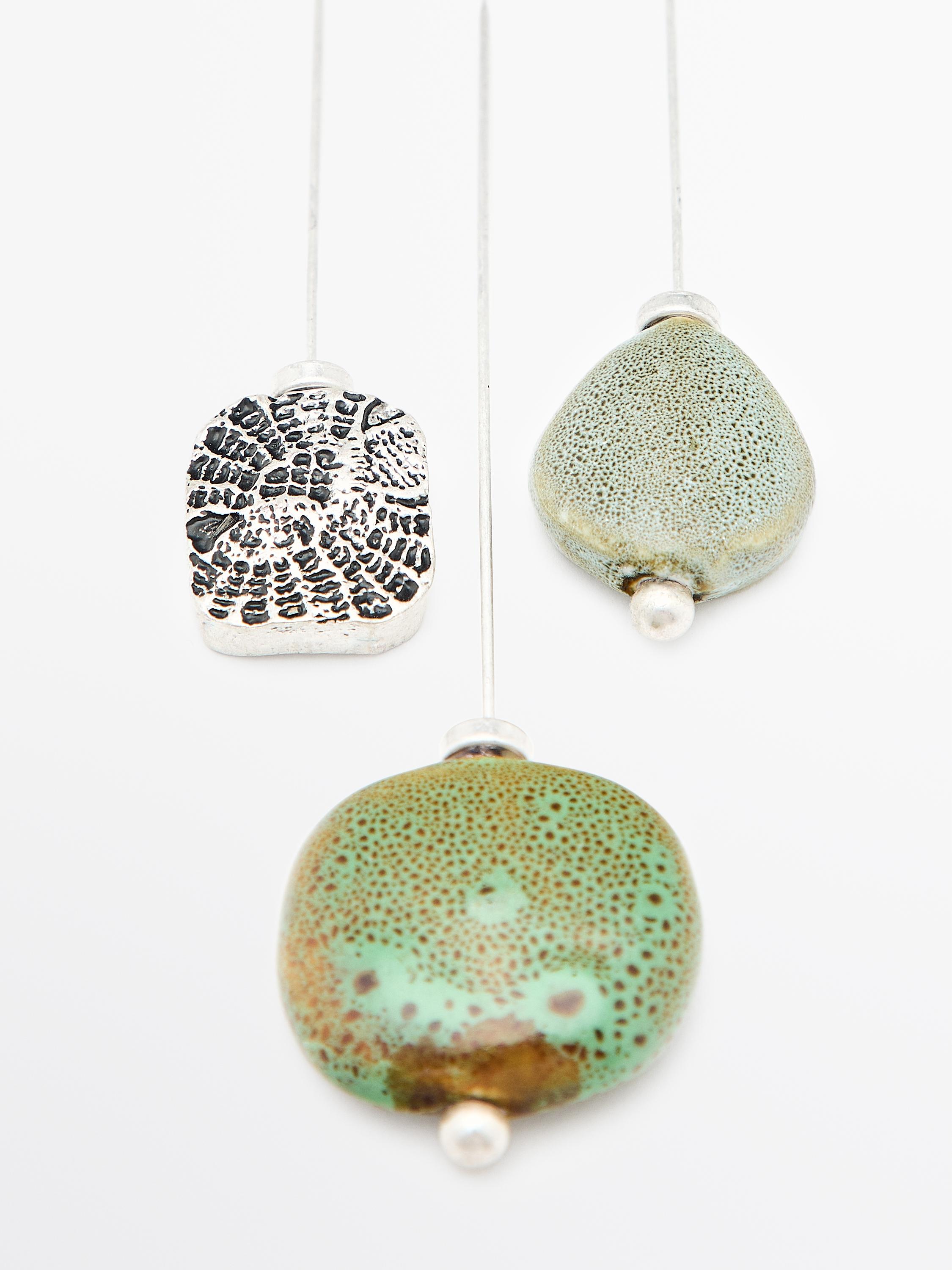Brooch with textured ceramic piece and medallion