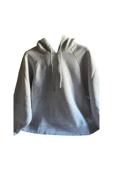 Light grey basic long-sleeved hoodie with drawstrings and ribbed trims on a white background.