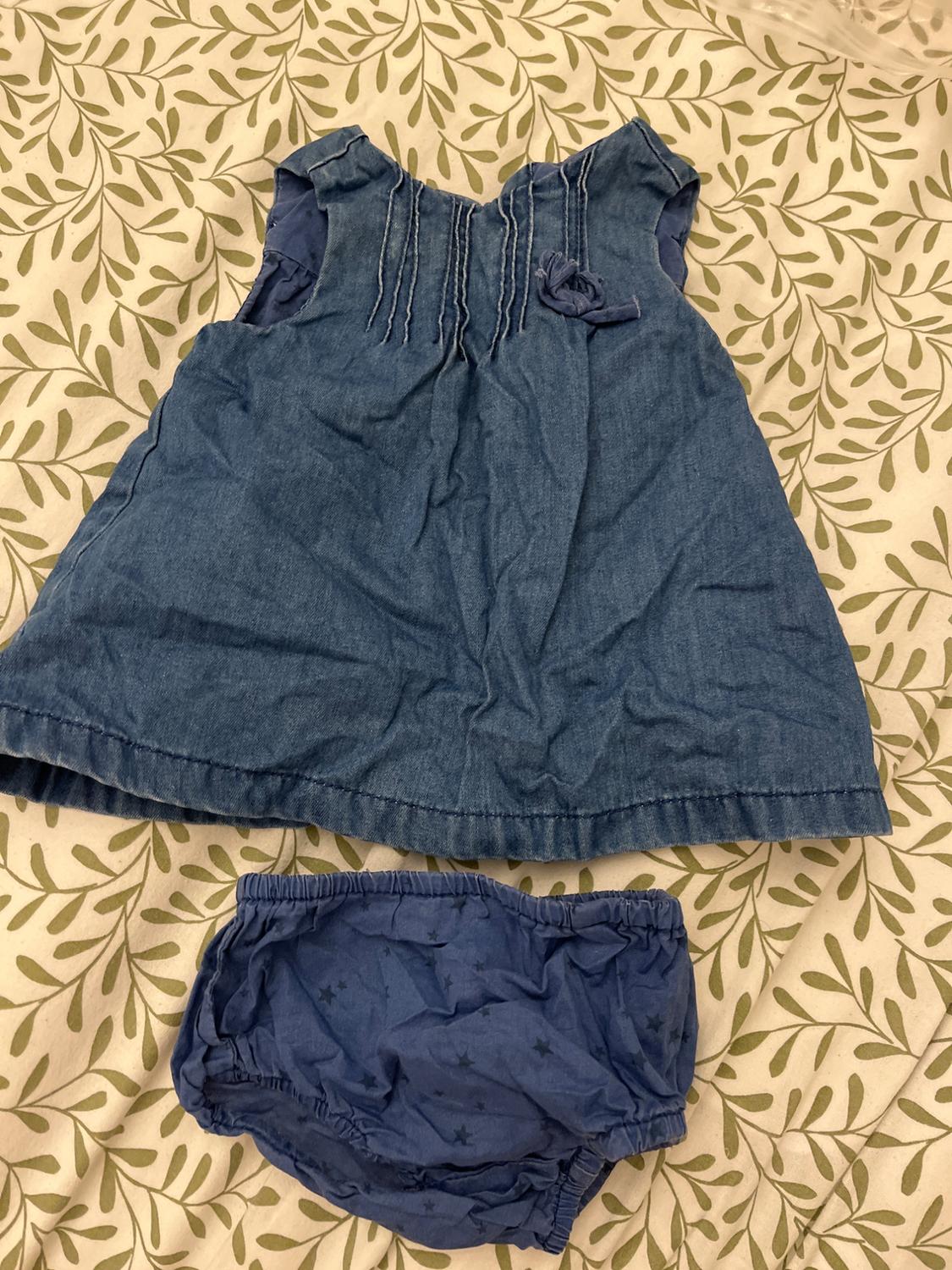 Front view of a blue dress with chest pleats and matching star-patterned trousers.