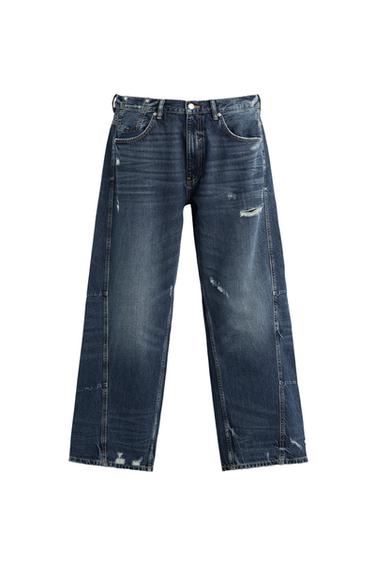 Front view of distressed blue jeans with visible front and back pockets.