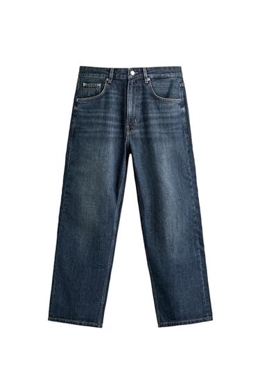Front view of blue washed-effect trousers, straight leg and cropped length. Button and zip fastening at the front, and front pockets.