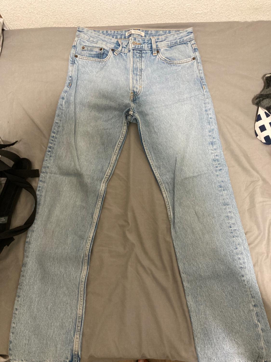 Front view of light blue denim jeans with front and back pockets.