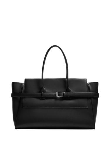 Front view of a black handbag with belt detail and two handles. Main compartment with double magnetic closure.
