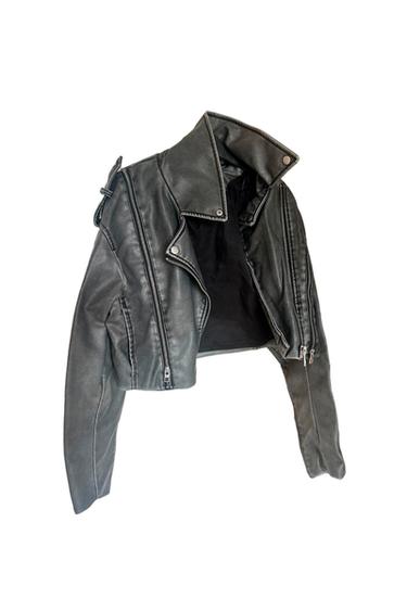 Black leather jacket with metallic zips and an asymmetric design, hanging against a white background.